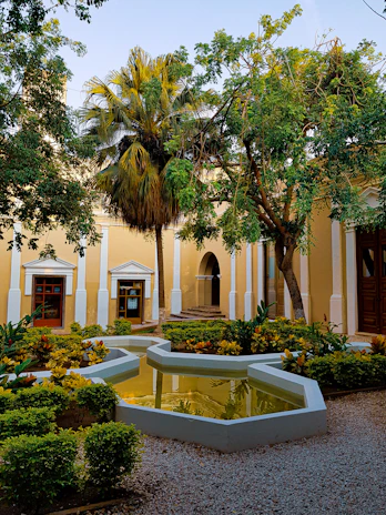 Peaceful courtyard view with lush greens and seating areas.