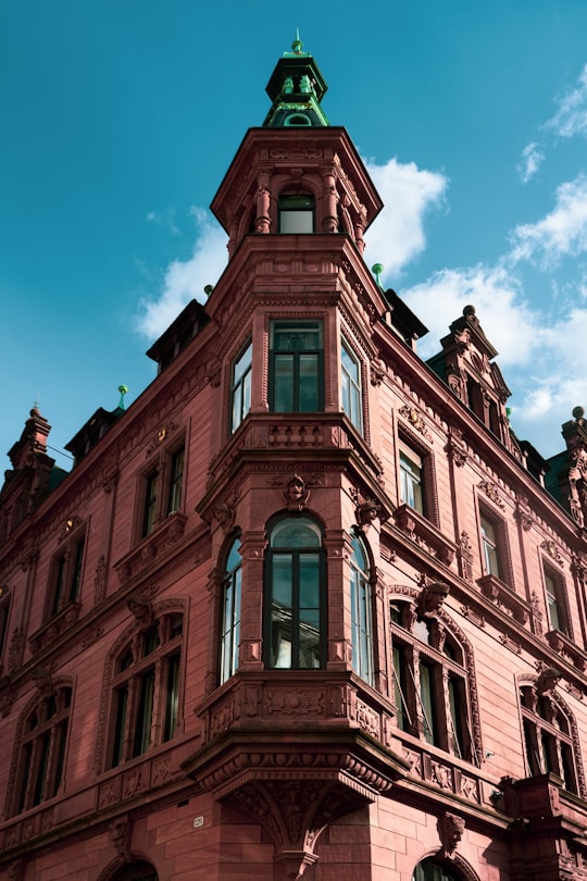 brown concrete building under blue sky during daytime in Die Kuh die lacht - Heidelberg Germany