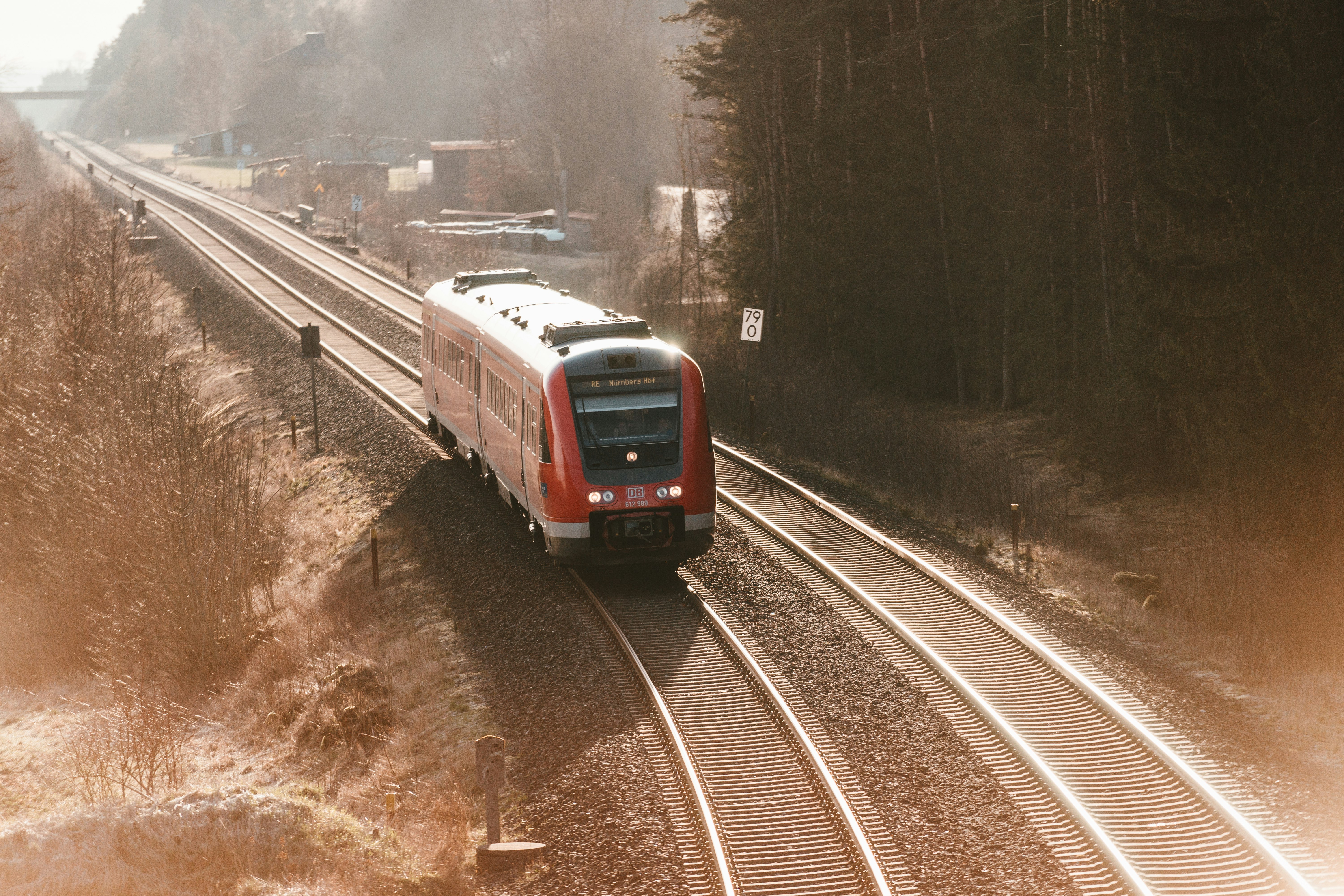 red and white train on rail road during daytime