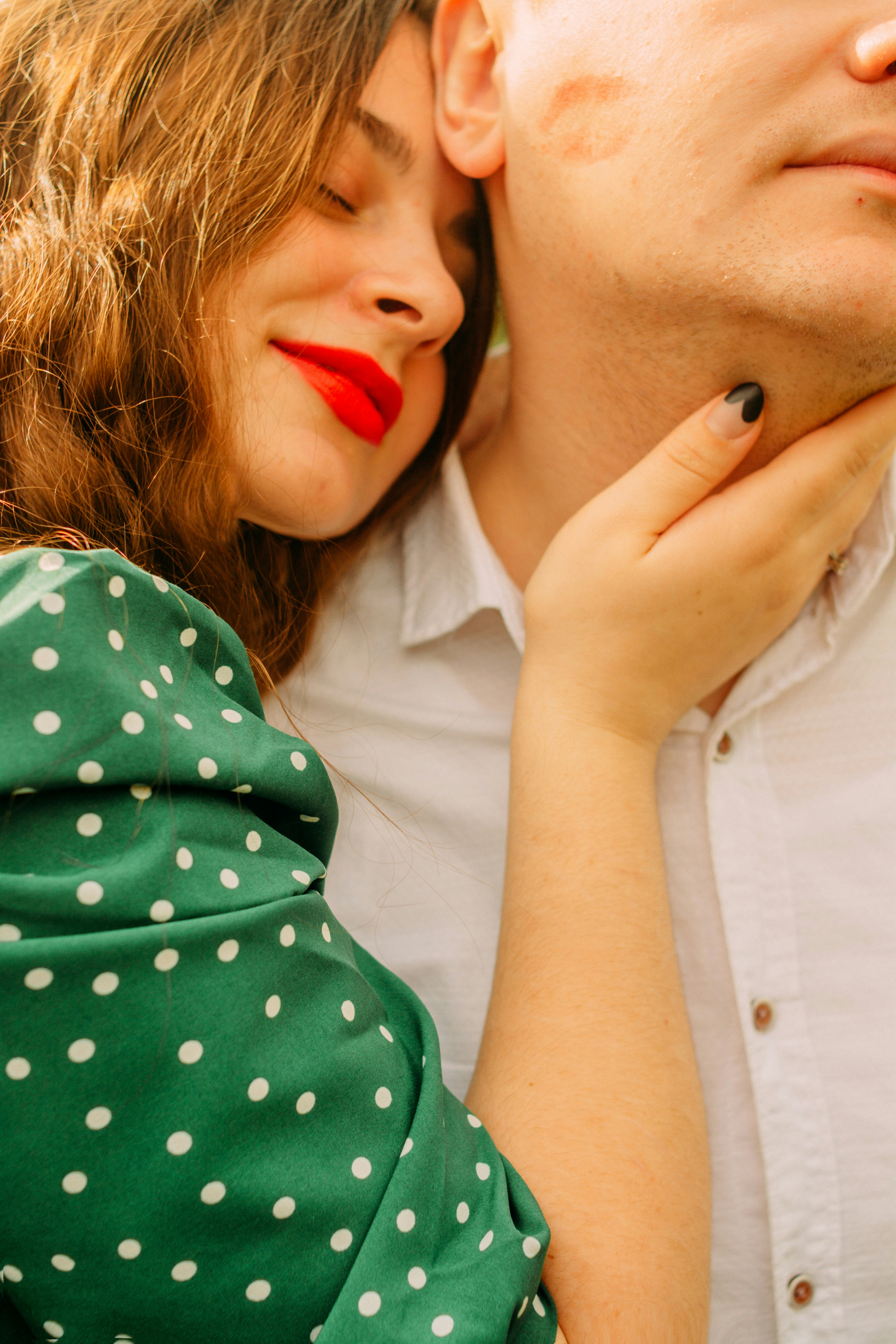 woman in white and green polka dot shirt