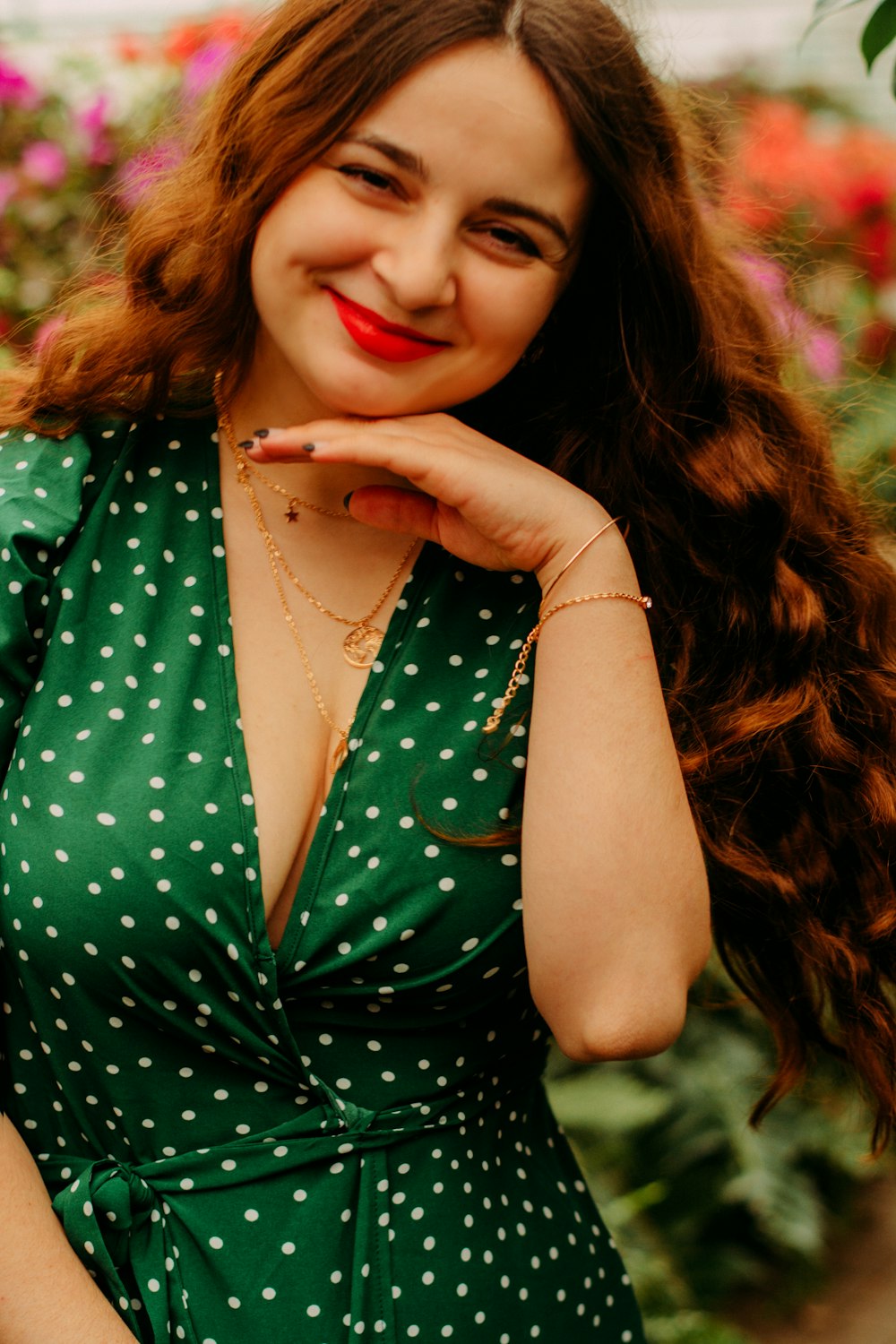 woman in green and black polka dot sleeveless shirt