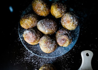 brown and white round food on black surface