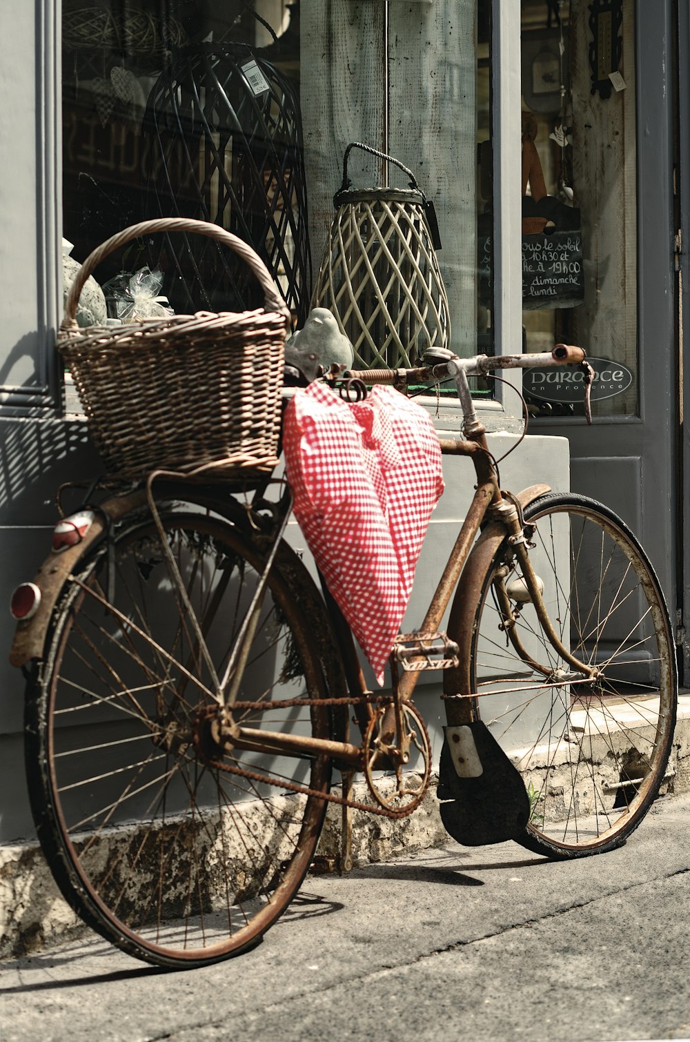 brown city bike with red and white plaid textile