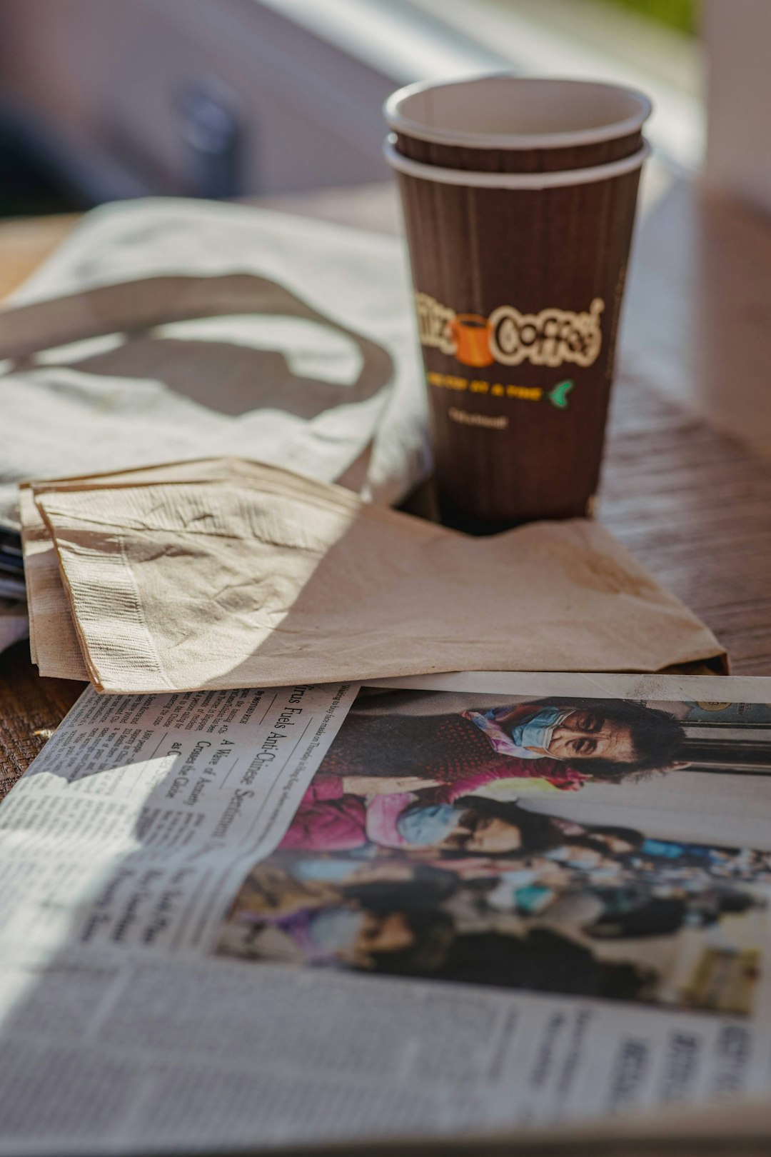 brown and white paper cup on brown wooden table