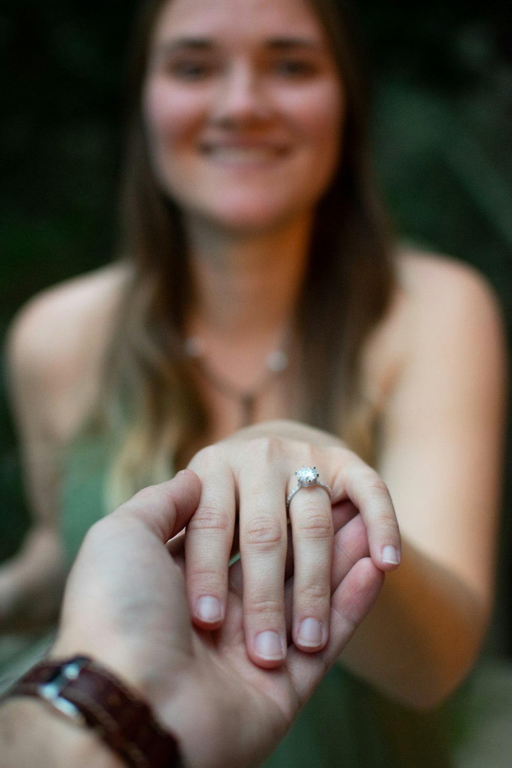 smiling woman with silver ring on her finger