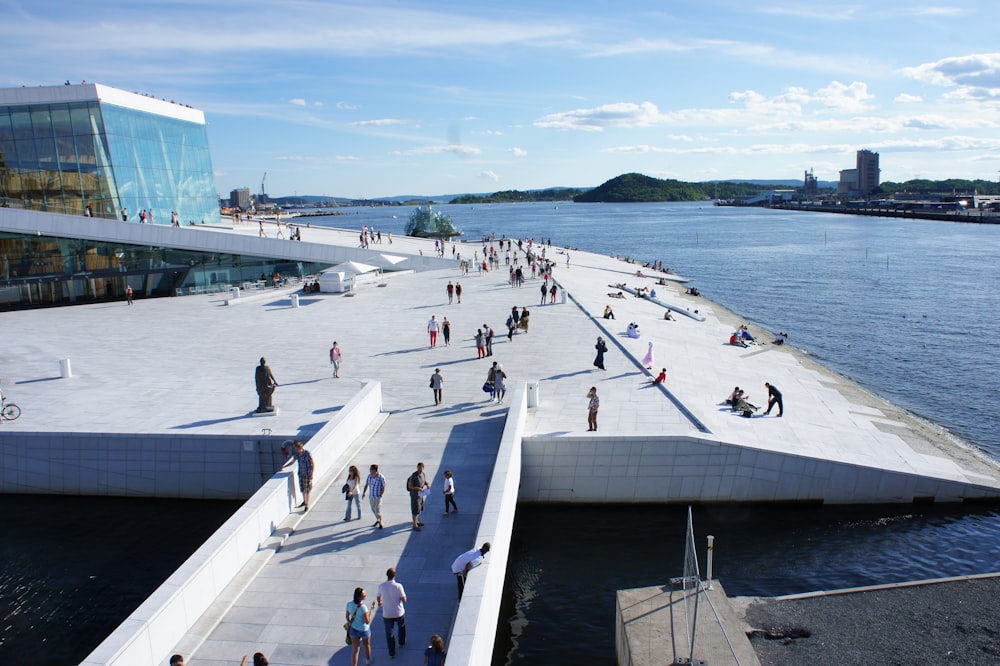 people walking on white concrete bridge during daytime