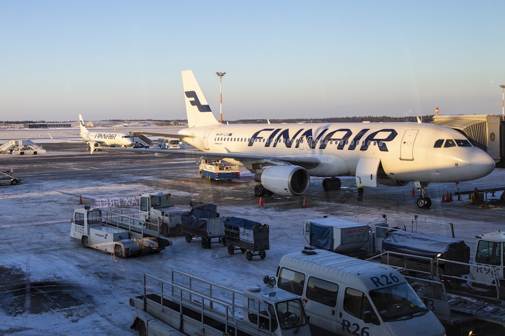 white and red passenger plane on airport during daytime