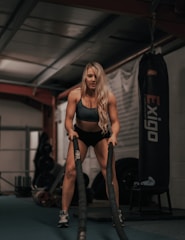 Strong woman lifting weights in gym, symbolizing female fitness and empowerment