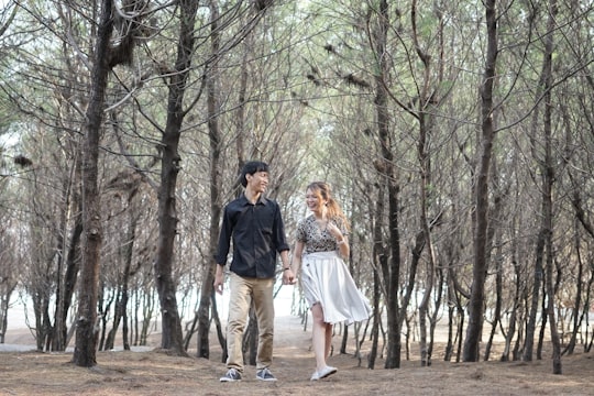 man and woman standing in forest during daytime in Yogyakarta Indonesia