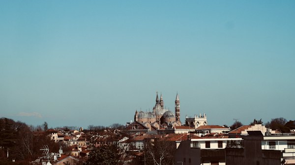 Brown and white concrete building under blue sky during daytime — Padua, Italy