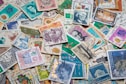 assorted postage stamps on blue and white textile