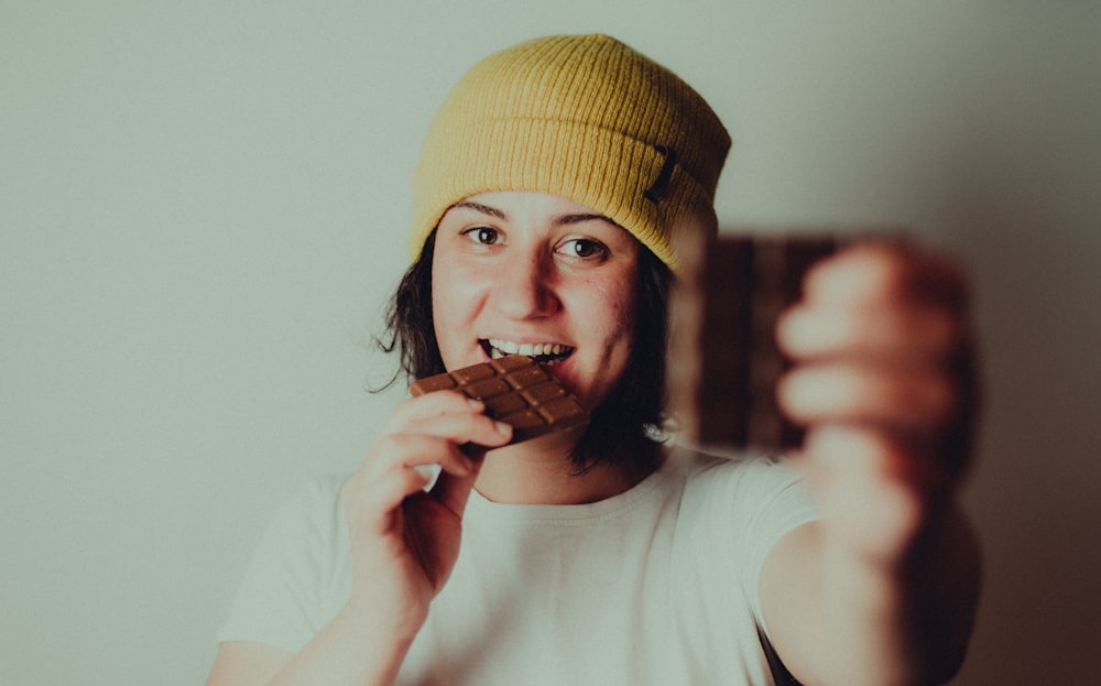 woman in white crew neck t-shirt wearing yellow knit cap