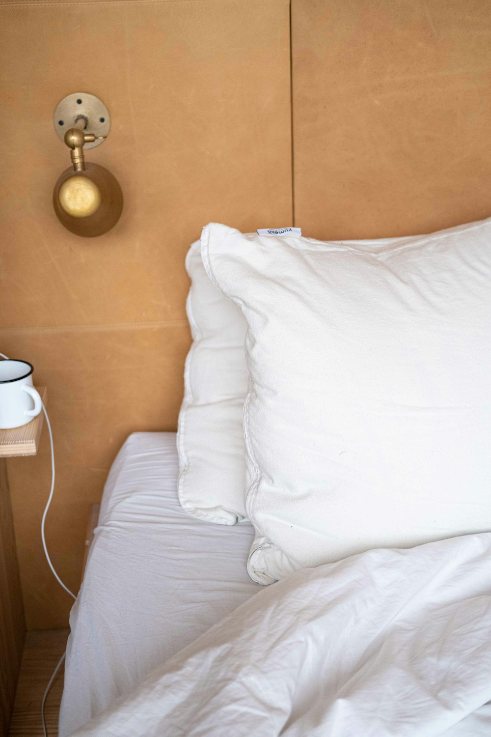 white pillow on white bed