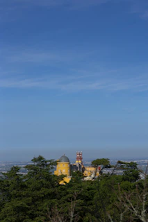 A vibrant photo of the Royal Palace of Madrid shining under a clear blue sky.