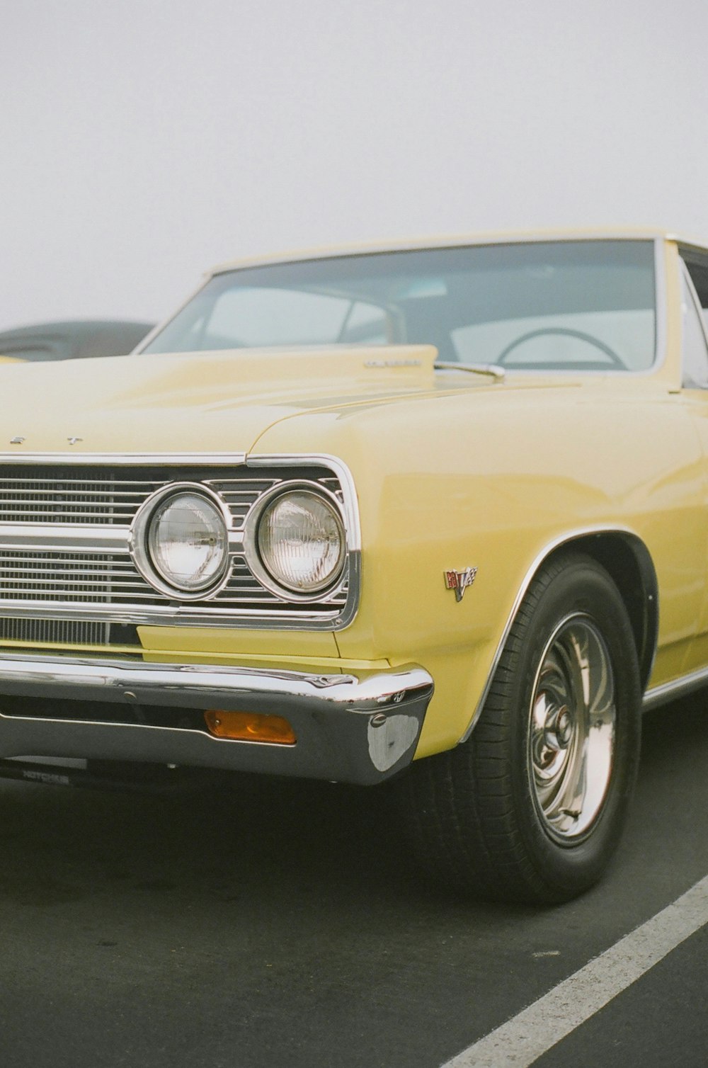 yellow classic car in close up photography