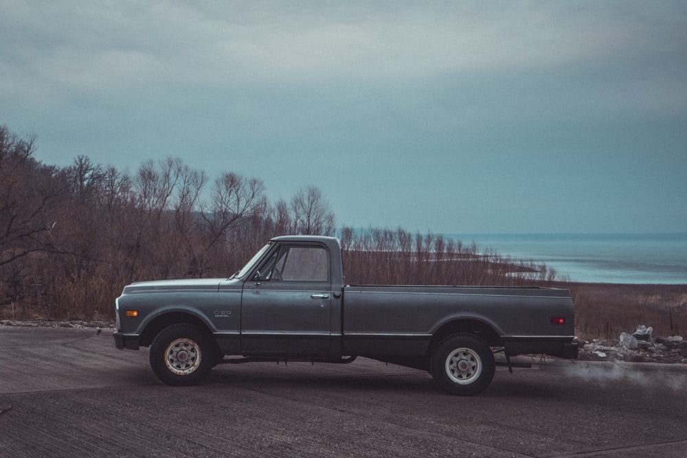 black single cab pickup truck on road during daytime