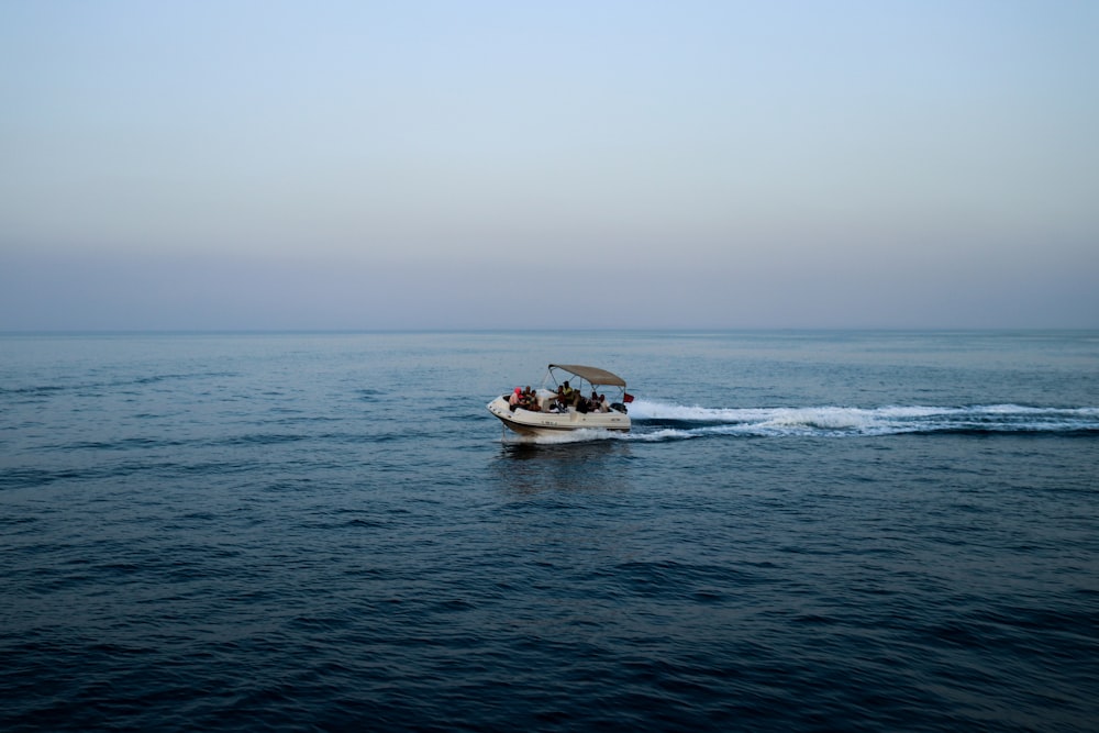 white and black boat on sea during daytime