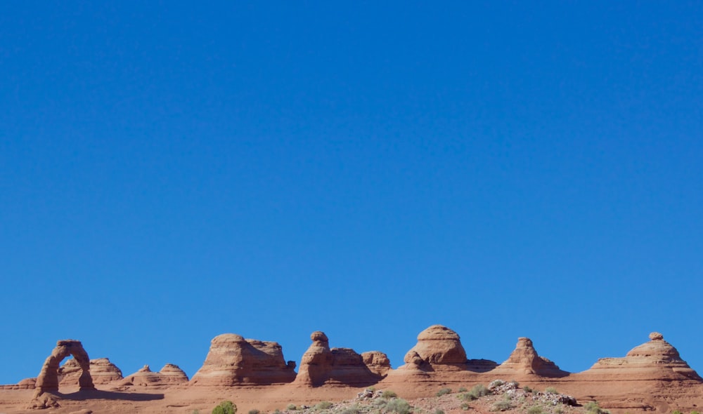 brown rock formation under blue sky during daytime