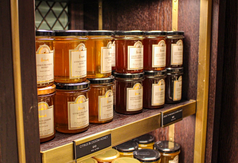 brown glass jars on brown wooden shelf