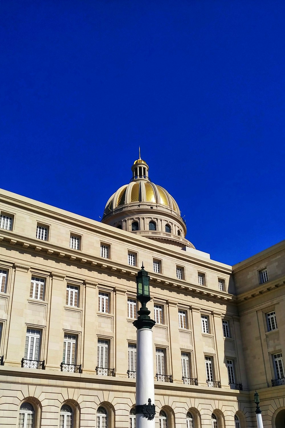 beige concrete building under blue sky during daytime