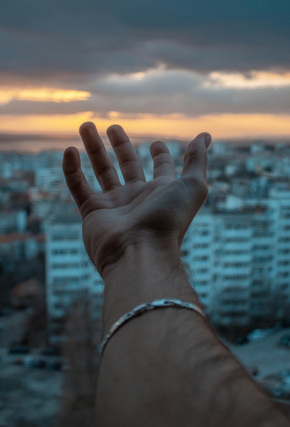 person wearing silver bracelet and silver bracelet