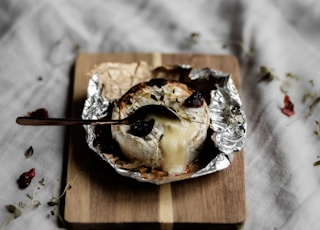 brown and white cake on brown wooden tray