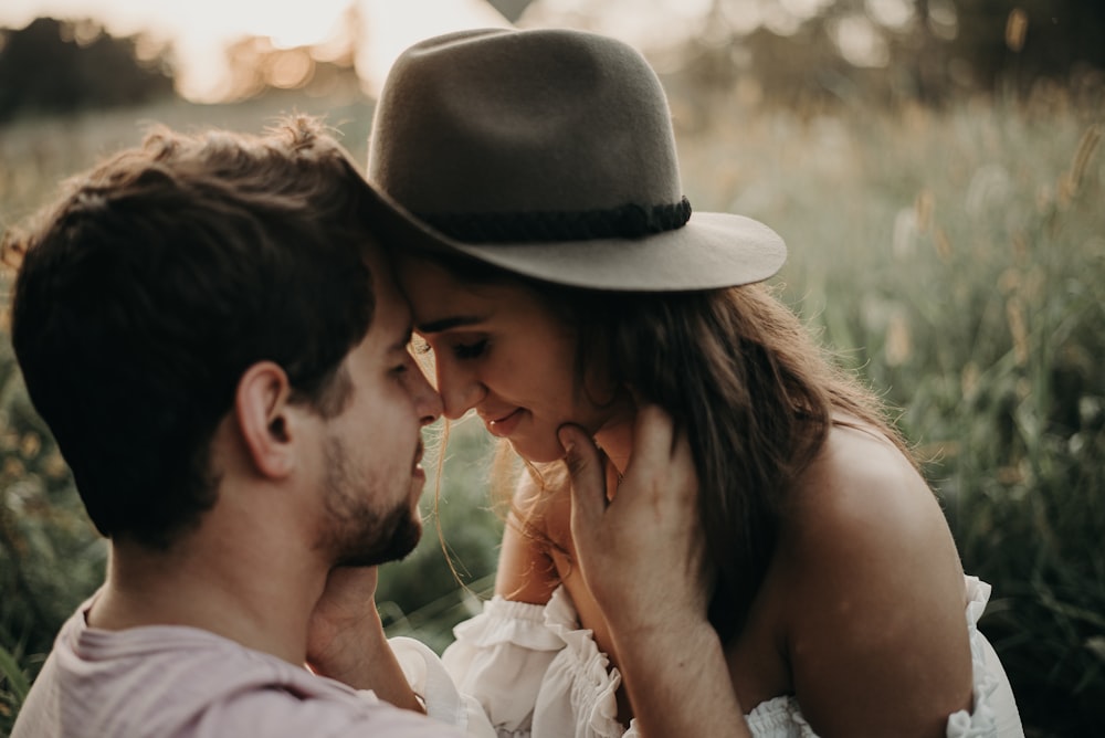 man and woman kissing during daytime