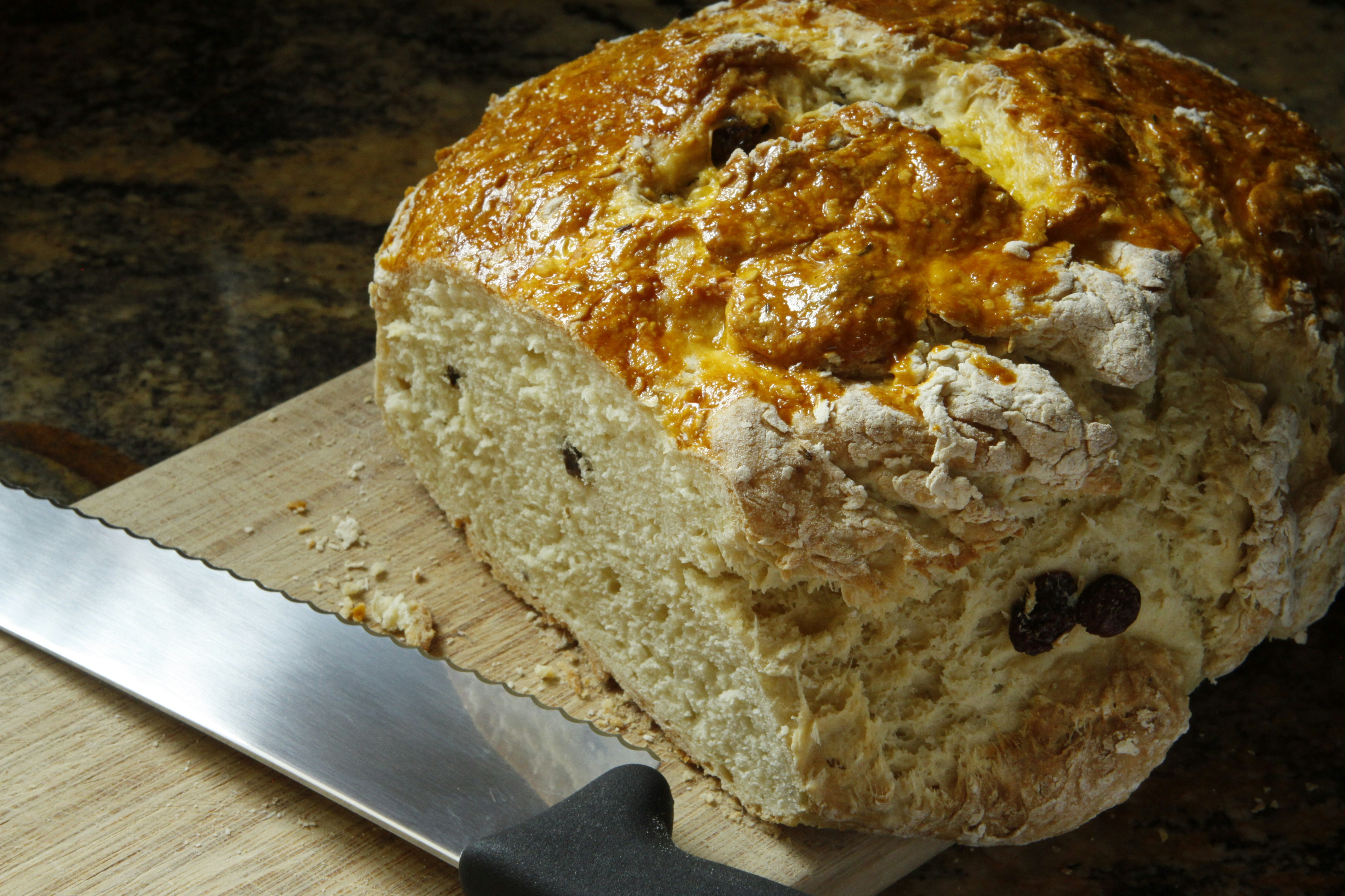 bread with cheese on brown wooden chopping board