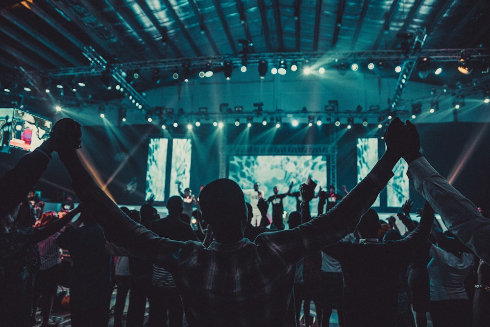 people standing on stage with lights