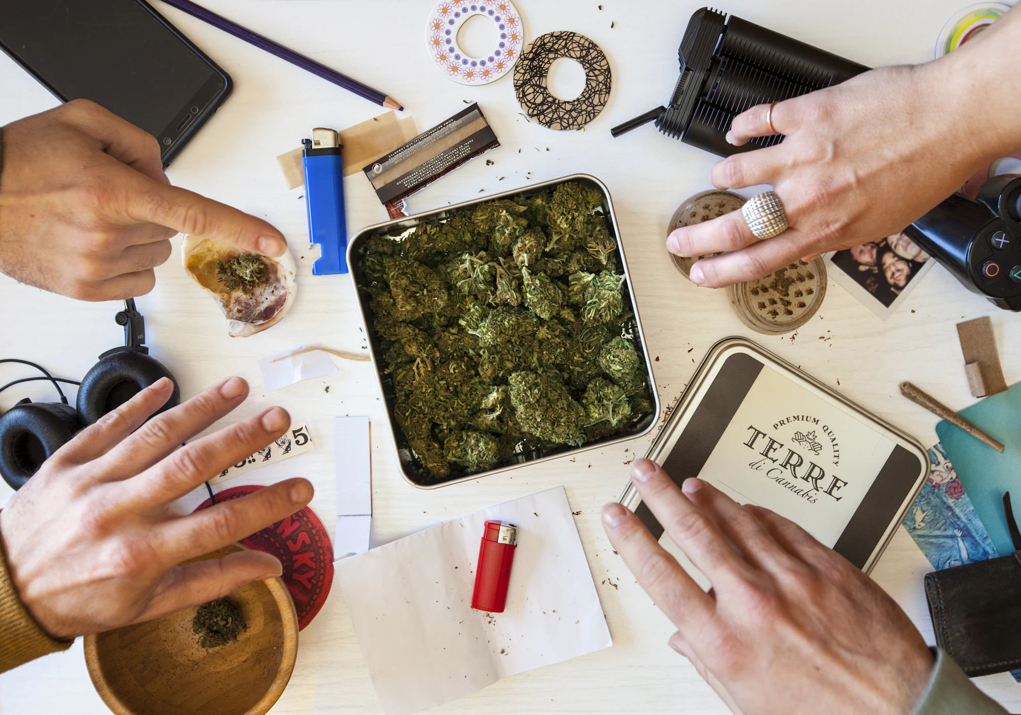 Hands rolling a joint at home