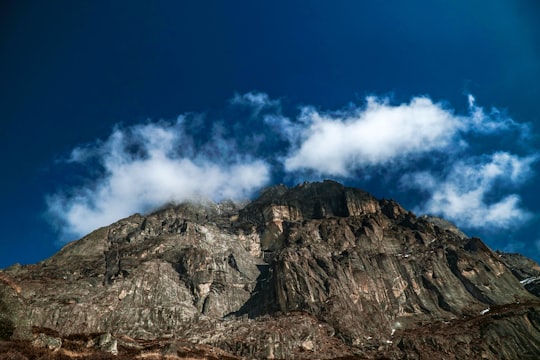 brown rocky mountain under blue sky and white clouds during daytime in Mera Peak Nepal