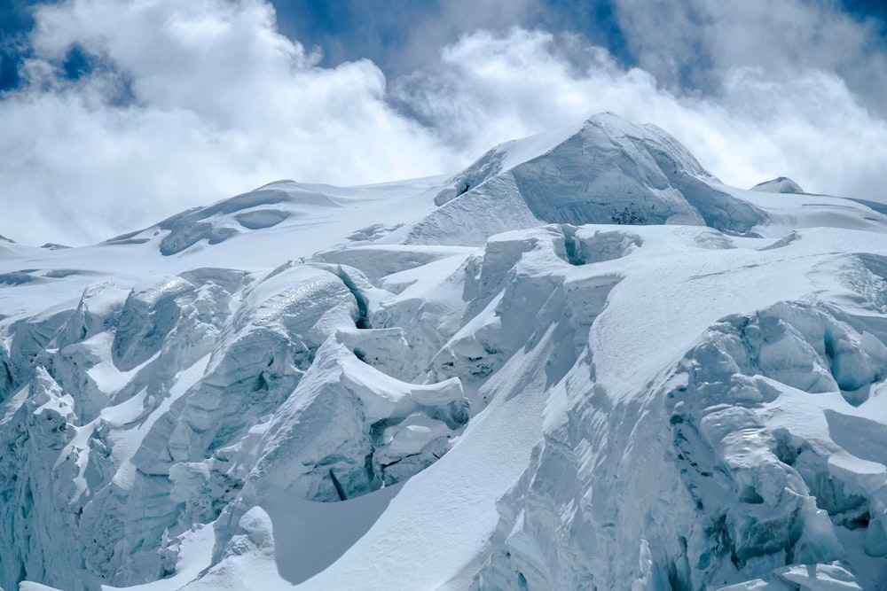 snow covered mountain under cloudy sky during daytime