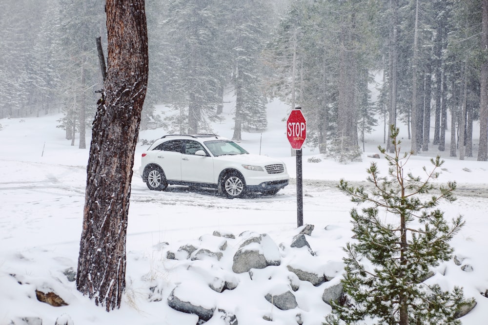 white sedan on snow covered road during daytime