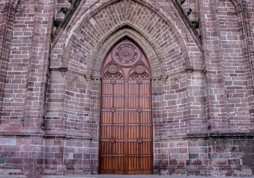 brown wooden door on gray concrete building