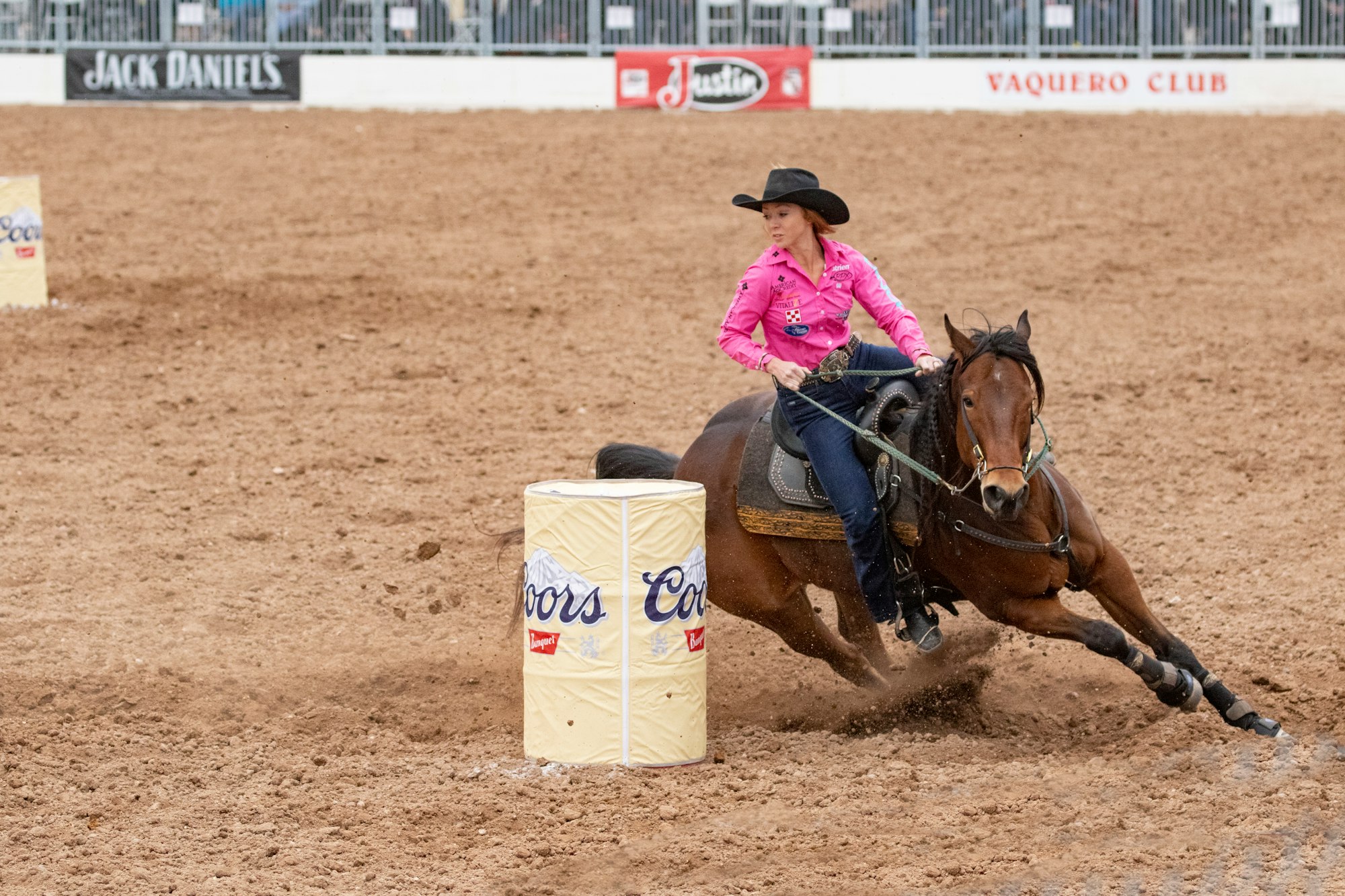 Emily Miller and her horse make a tight turn around a barrel before taking first place in barrel racing.