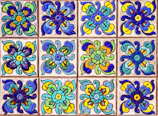 Brightly colored decorative tiles arranged in a geometric pattern on a wall.