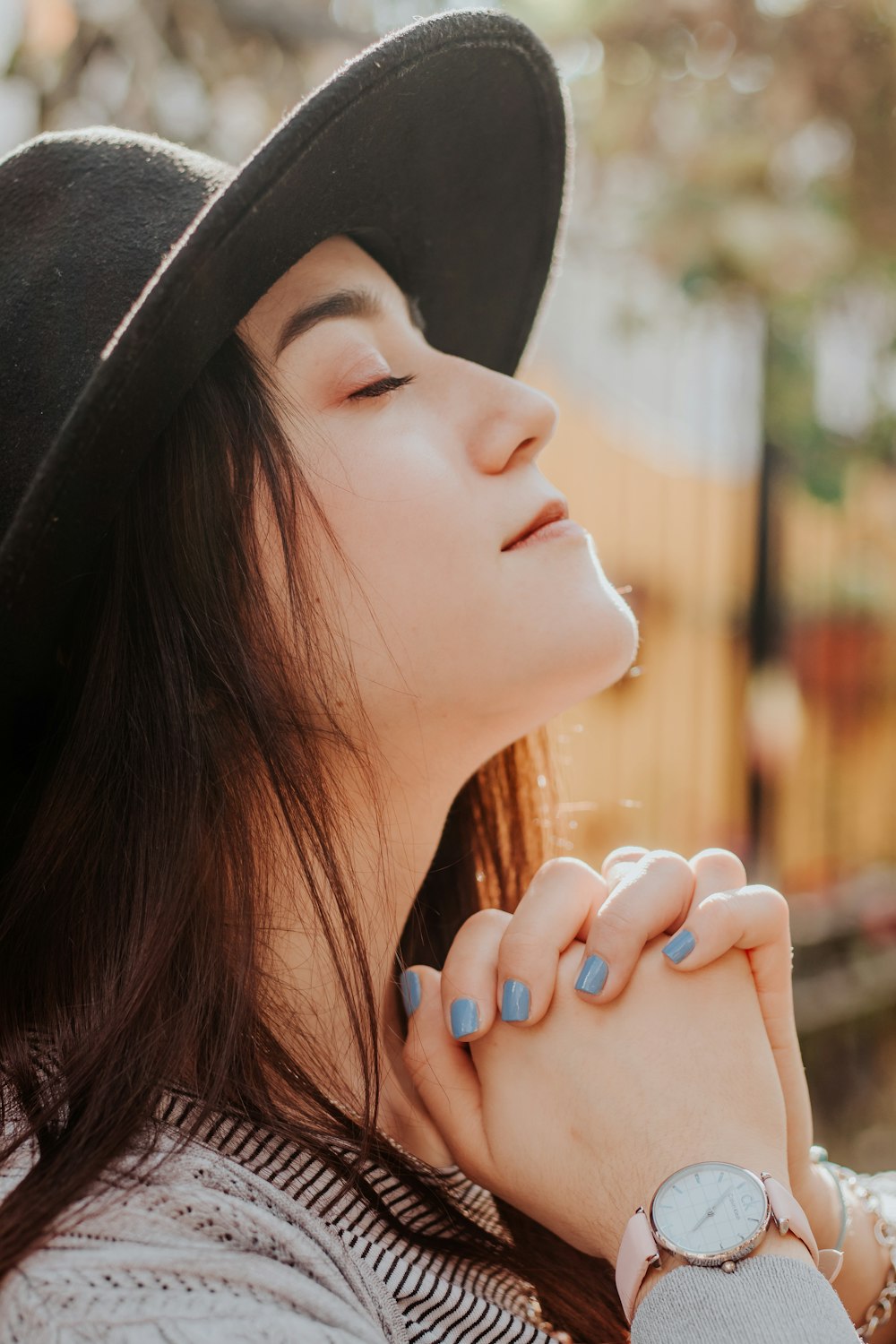 woman in black hat looking at her left side