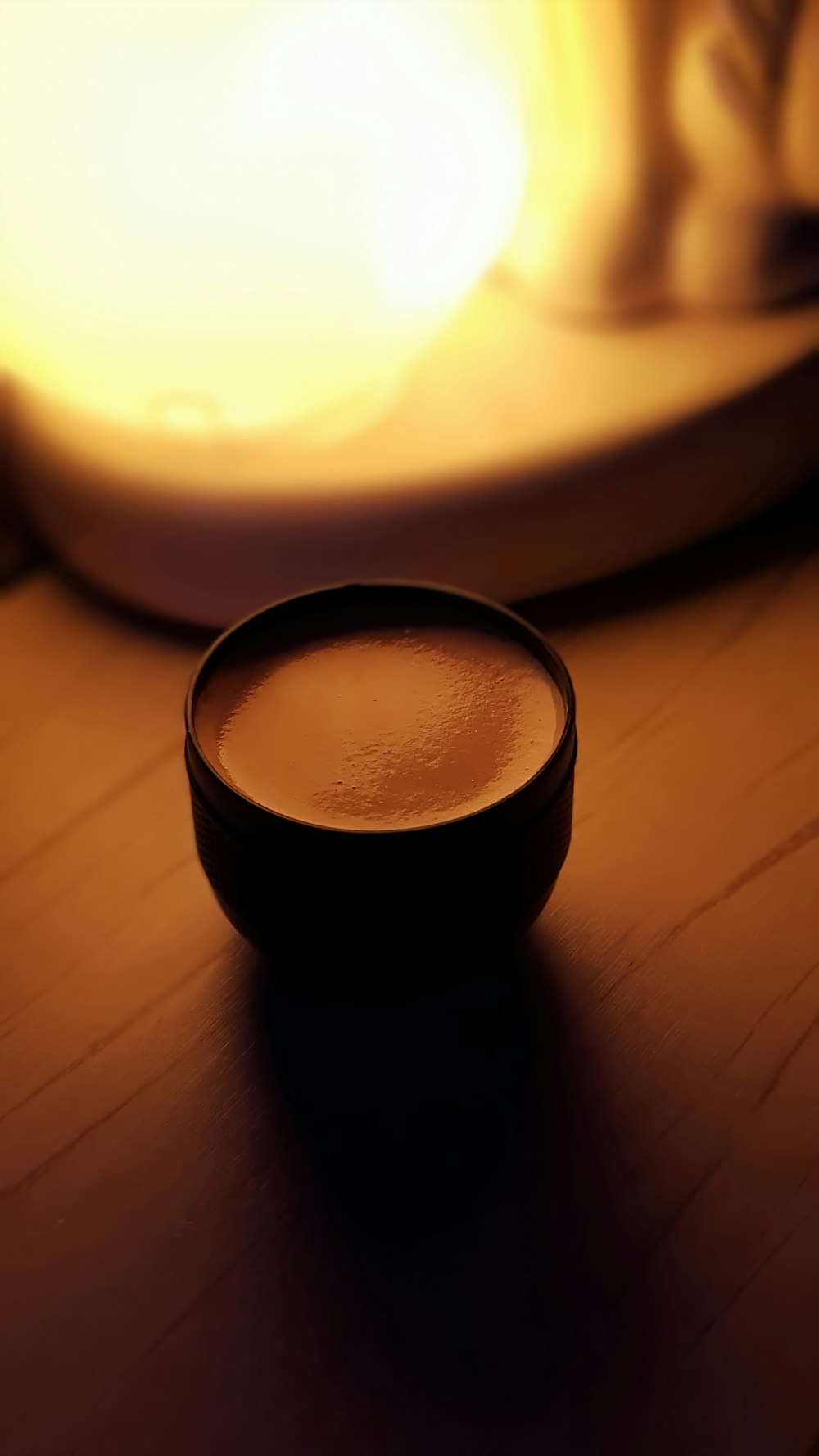 black ceramic mug on brown wooden table