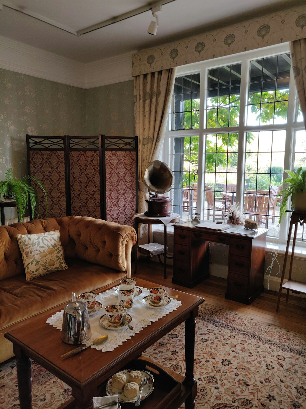 brown wooden table with white and brown floral table cloth