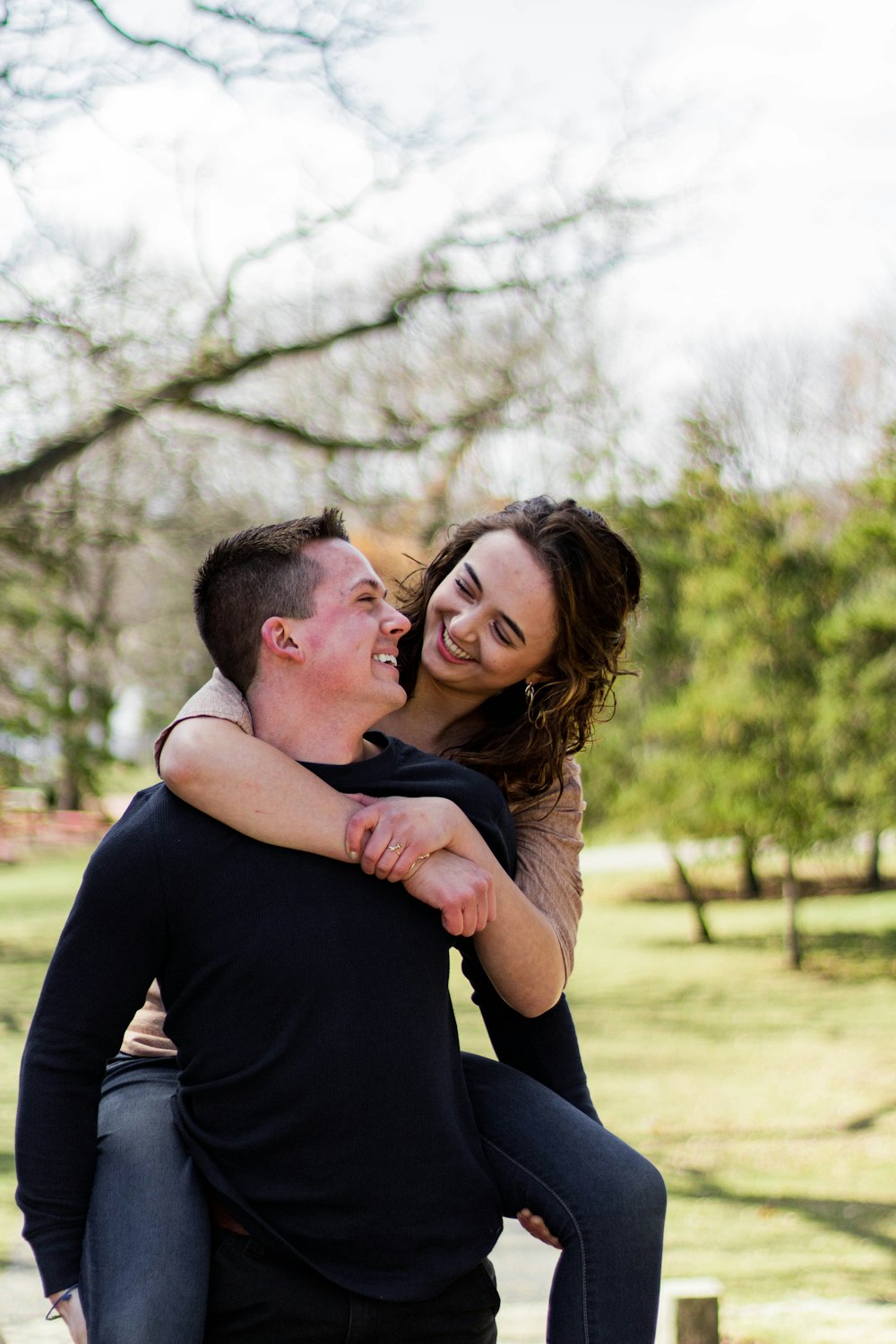 man in black long sleeve shirt hugging woman in black long sleeve shirt