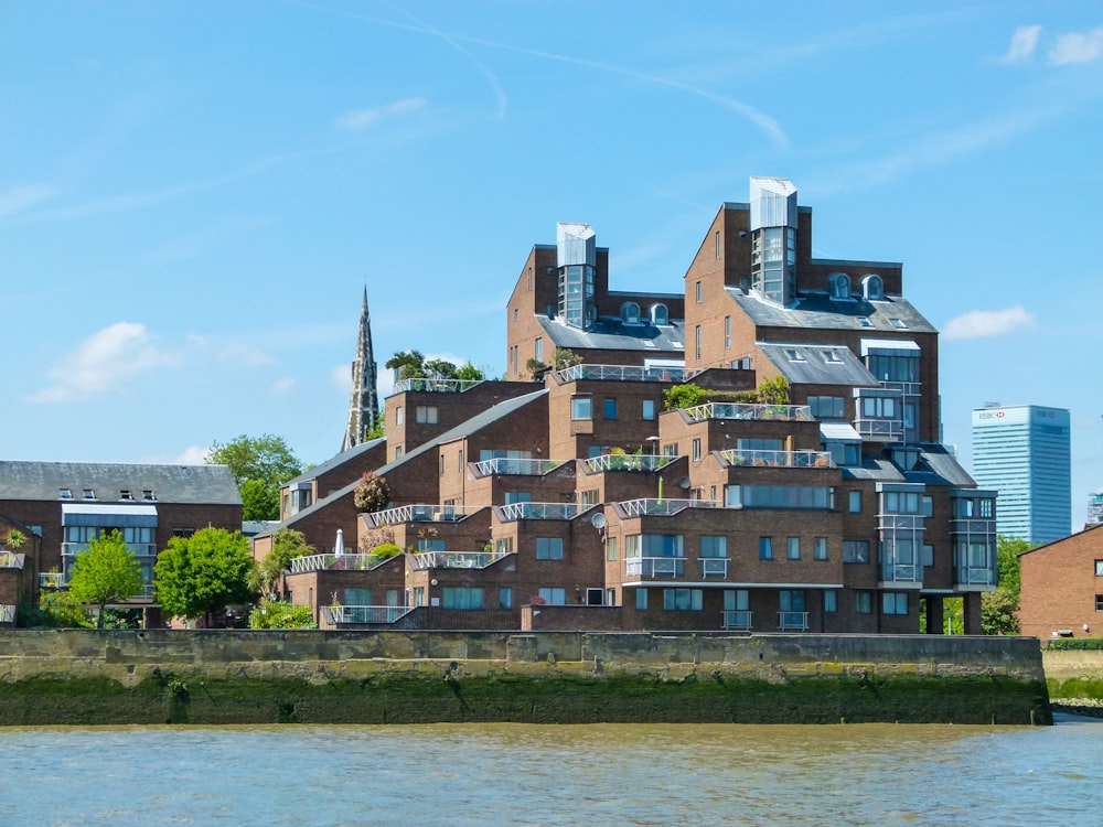 brown and white concrete buildings near body of water during daytime