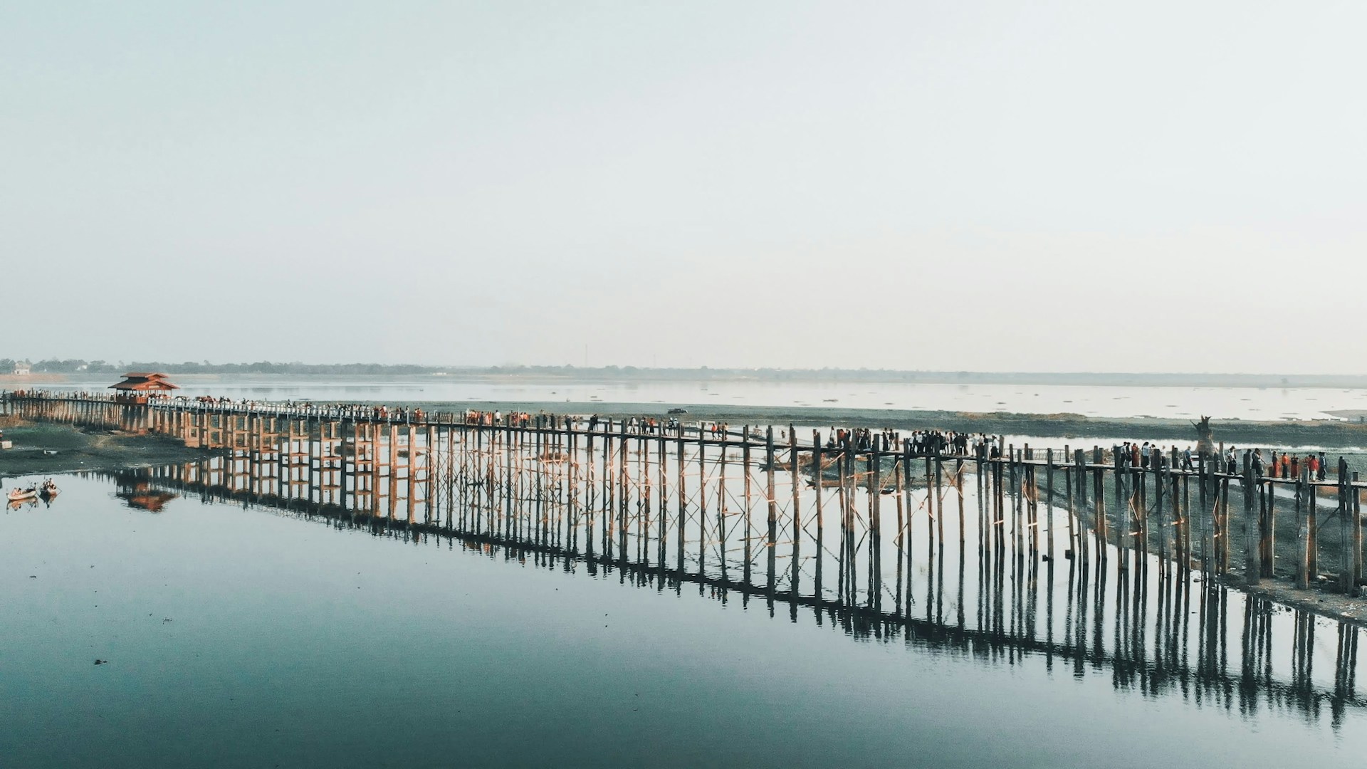 brown wooden dock on sea under white sky during daytime