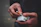 Close-up of a hand holding a pack of cigarettes with a sleek, minimalist background.