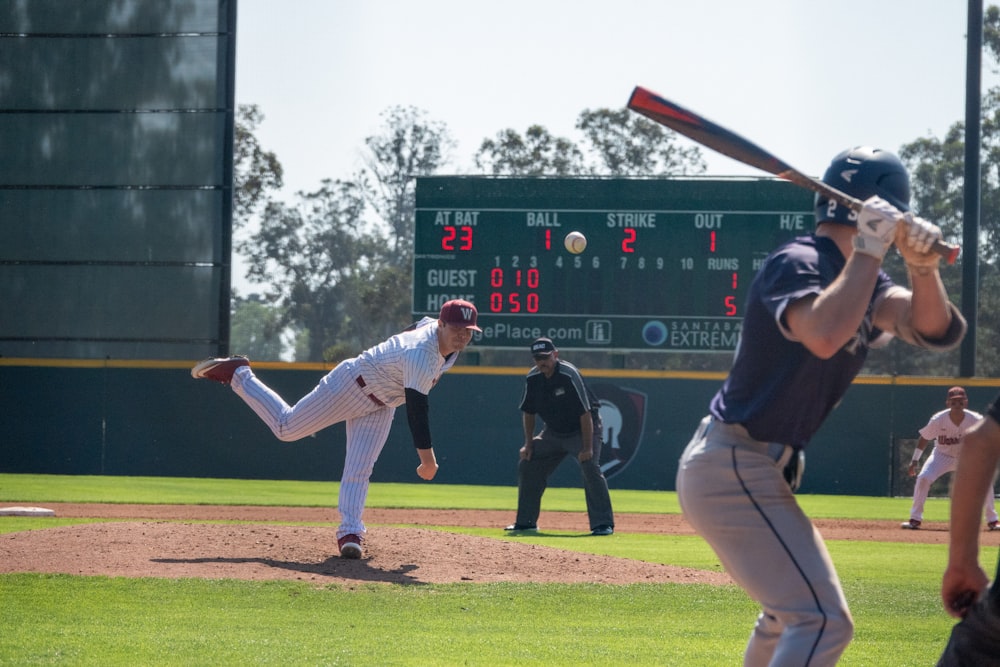 man in black and white jersey shirt and white pants playing baseball during daytime