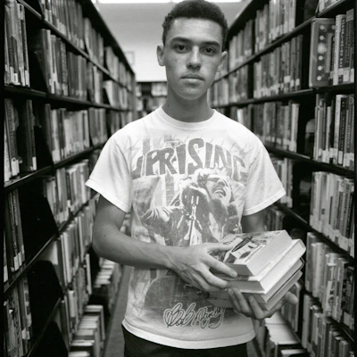 A young student proudly holding books received through our education support program.