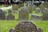 A satisfied customer standing next to a beautifully designed gravestone.
