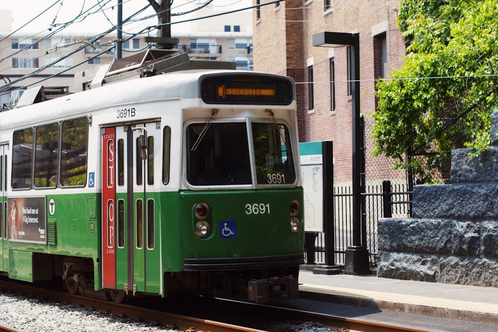 green and white tram on road during daytime