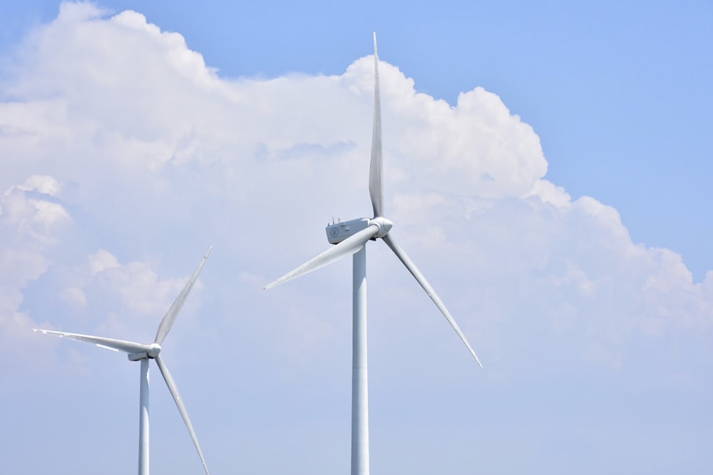 Weiße Windkraftanlage tagsüber unter blauem Himmel