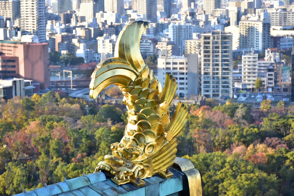 gold statue on top of building