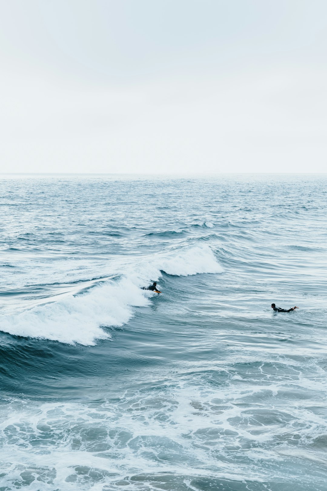 person surfing on sea waves during daytime